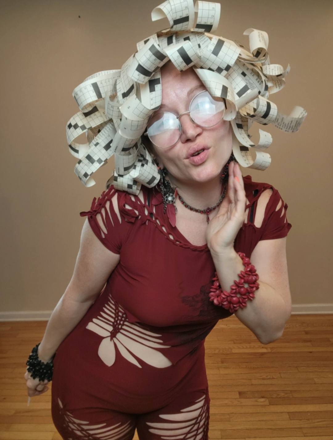 Donna Marie Milligan wearing a crossword paper wig sculpted into a voluminous updo.