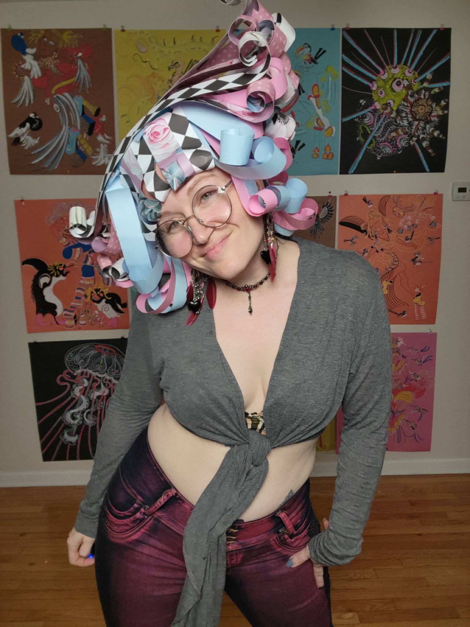 Donna Marie Milligan wearing a harlequin paper wig with black-and-white patterning and pastel curls.
