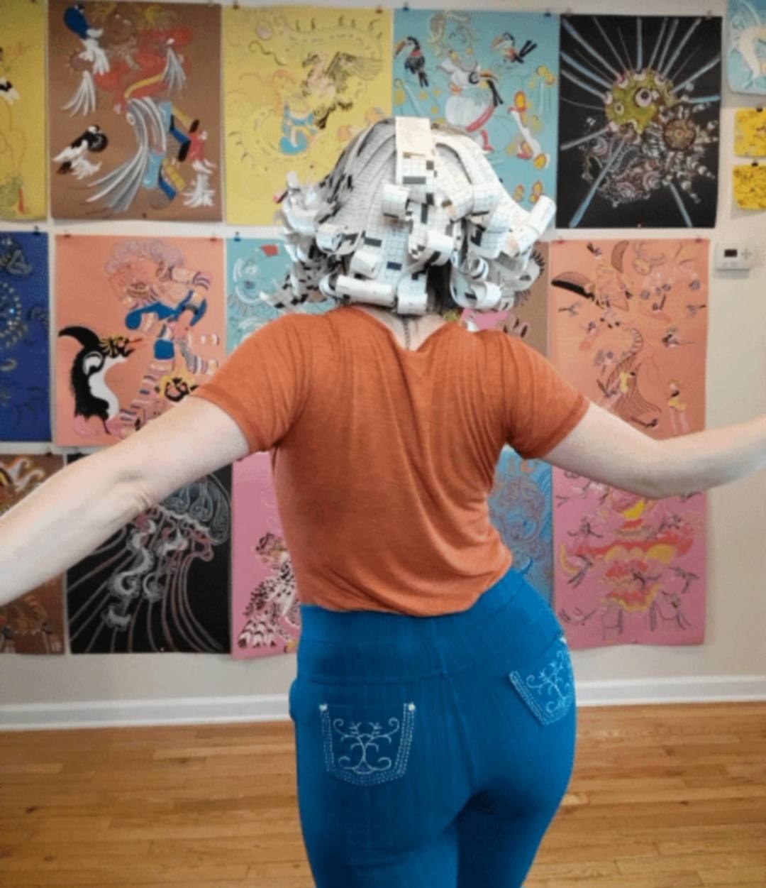 Back view of a crossword paper wig by Donna Marie Milligan showing the sculptural paper structure.