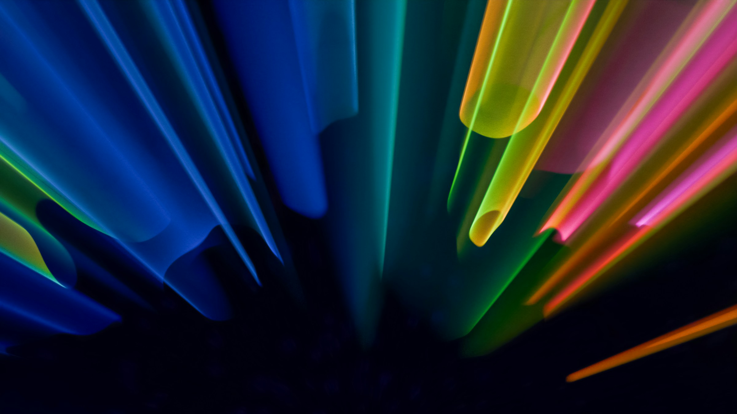Colorful abstract light rays radiating outward in blue, green, yellow and pink
