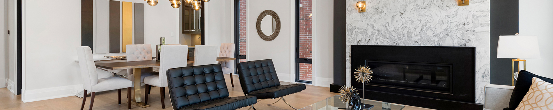 Elegant living and dining area with marble fireplace and gold accents