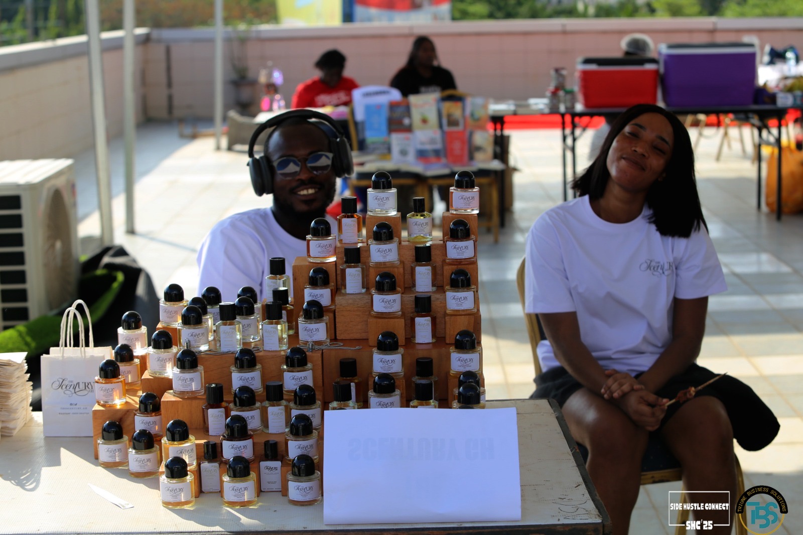 Entrepreneurs showcasing perfume products