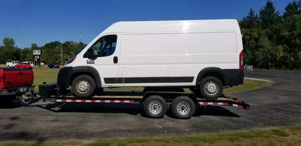 White van on car hauler trailer