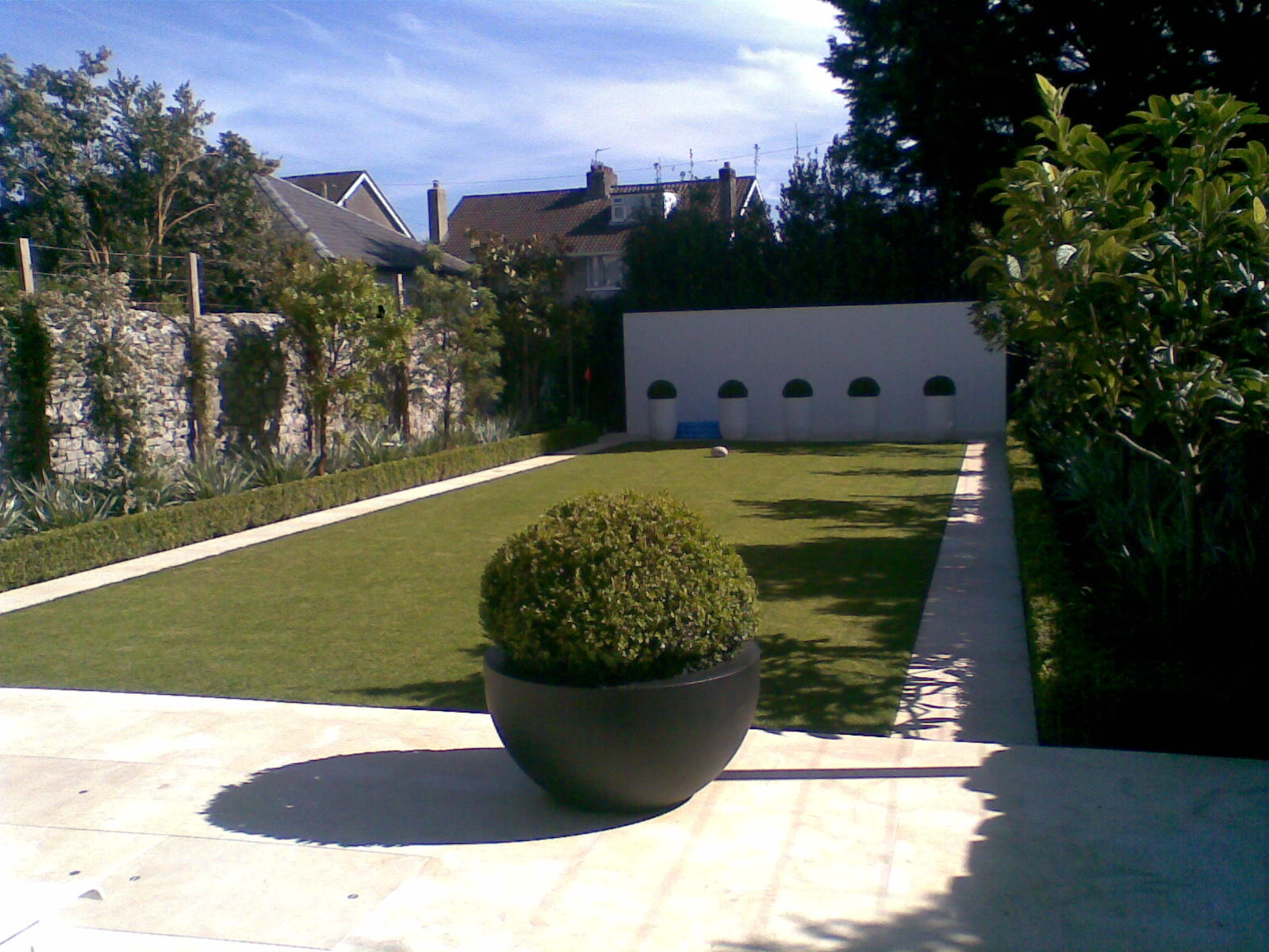 Landscaped courtyard garden with paving and mixed borders