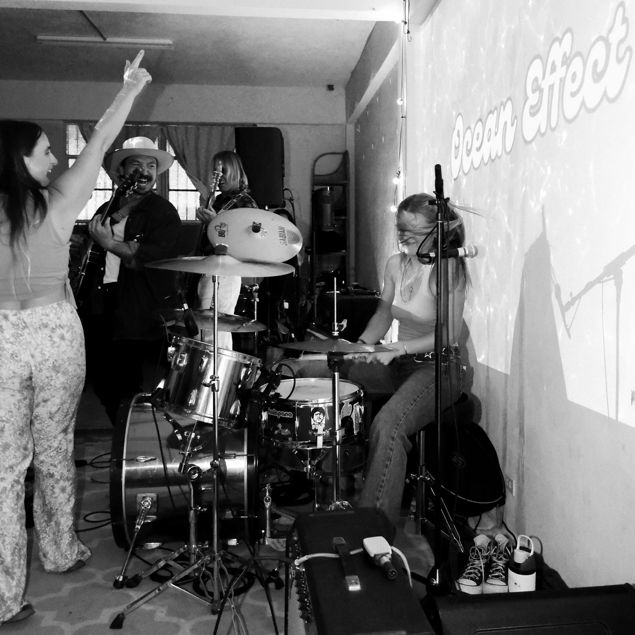 Full band on stage with drummer