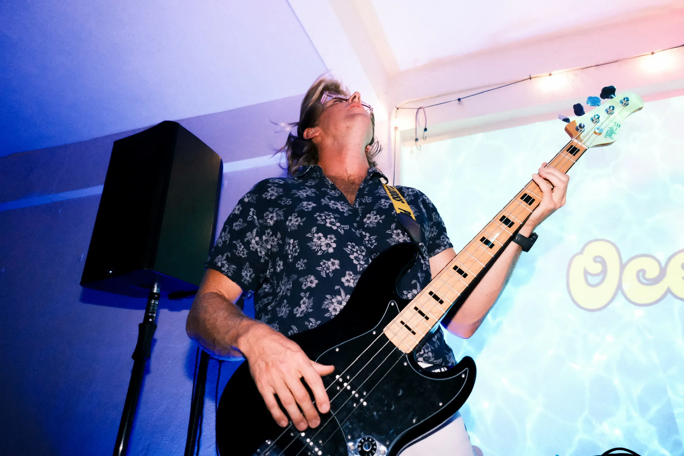 Bassist performing with blue lighting