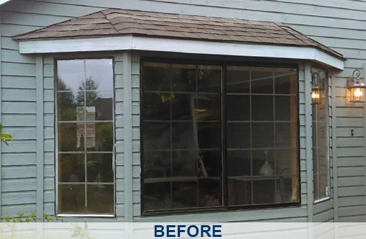 Old, outdated window with multiple small panes and dark frames