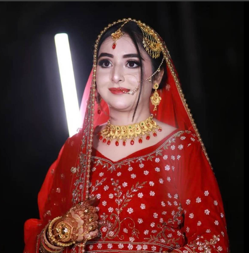 Bridal portrait in red lehenga with gold jewelry at Kaizen
