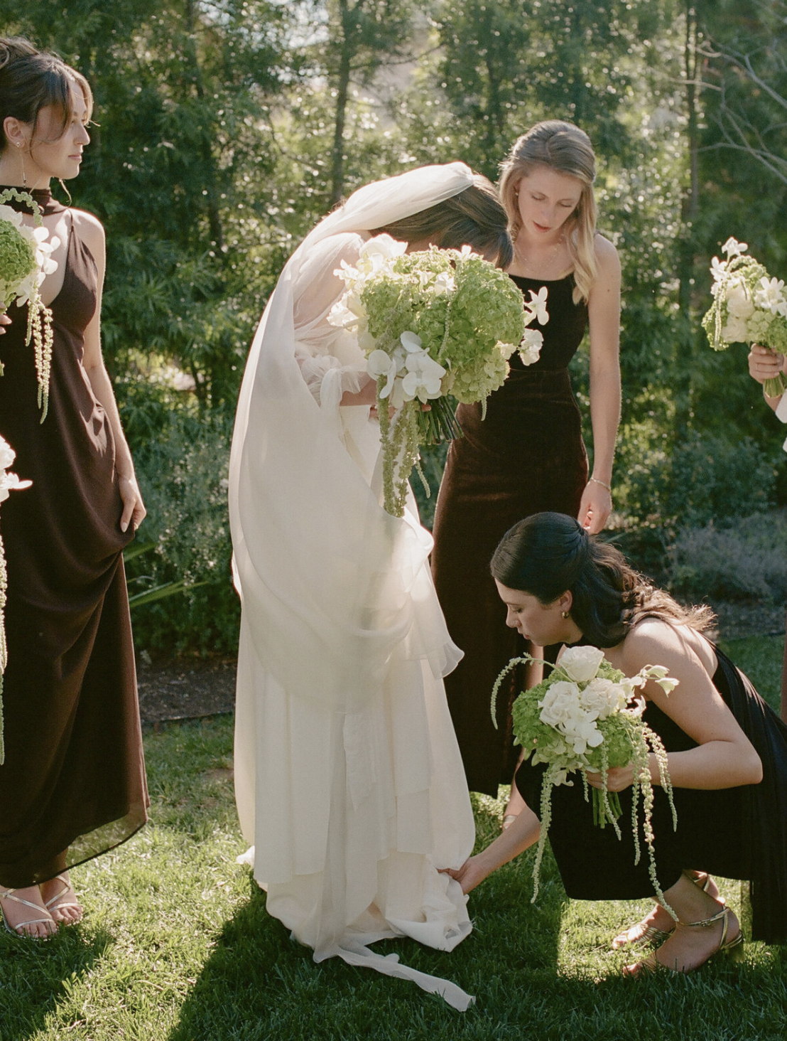 Bridesmaids helping bride
