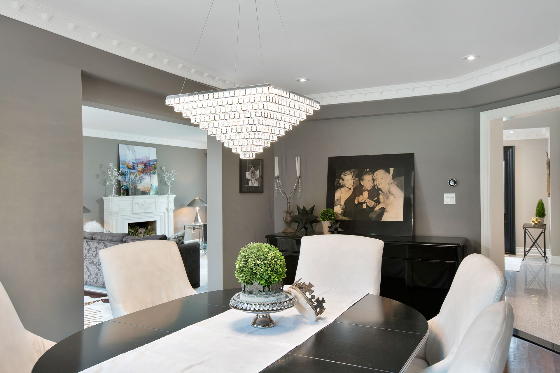 Elegant dining room with a crystal chandelier and black round table