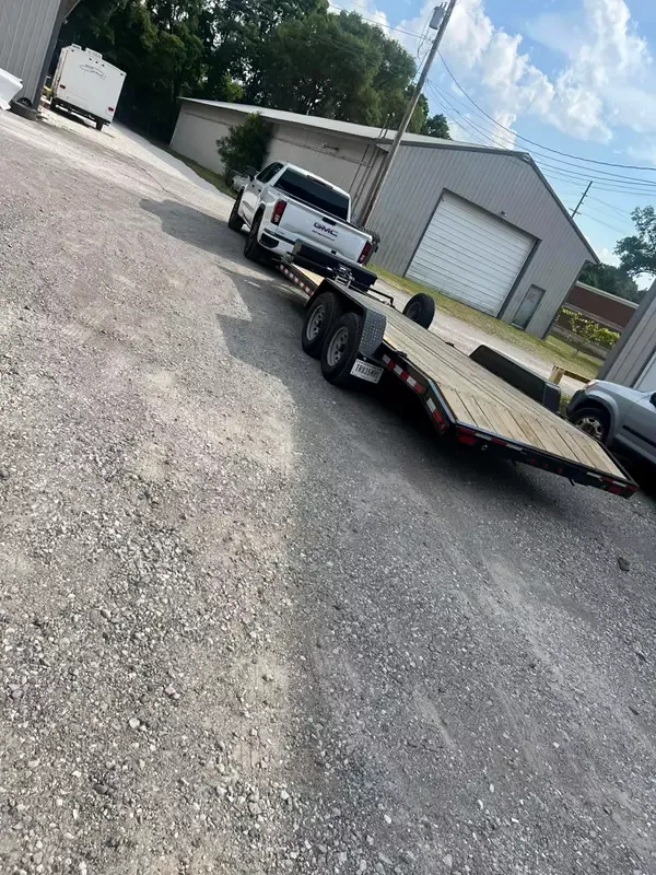 Car hauler trailer with diamond plate steel fenders and reinforced loading ramps