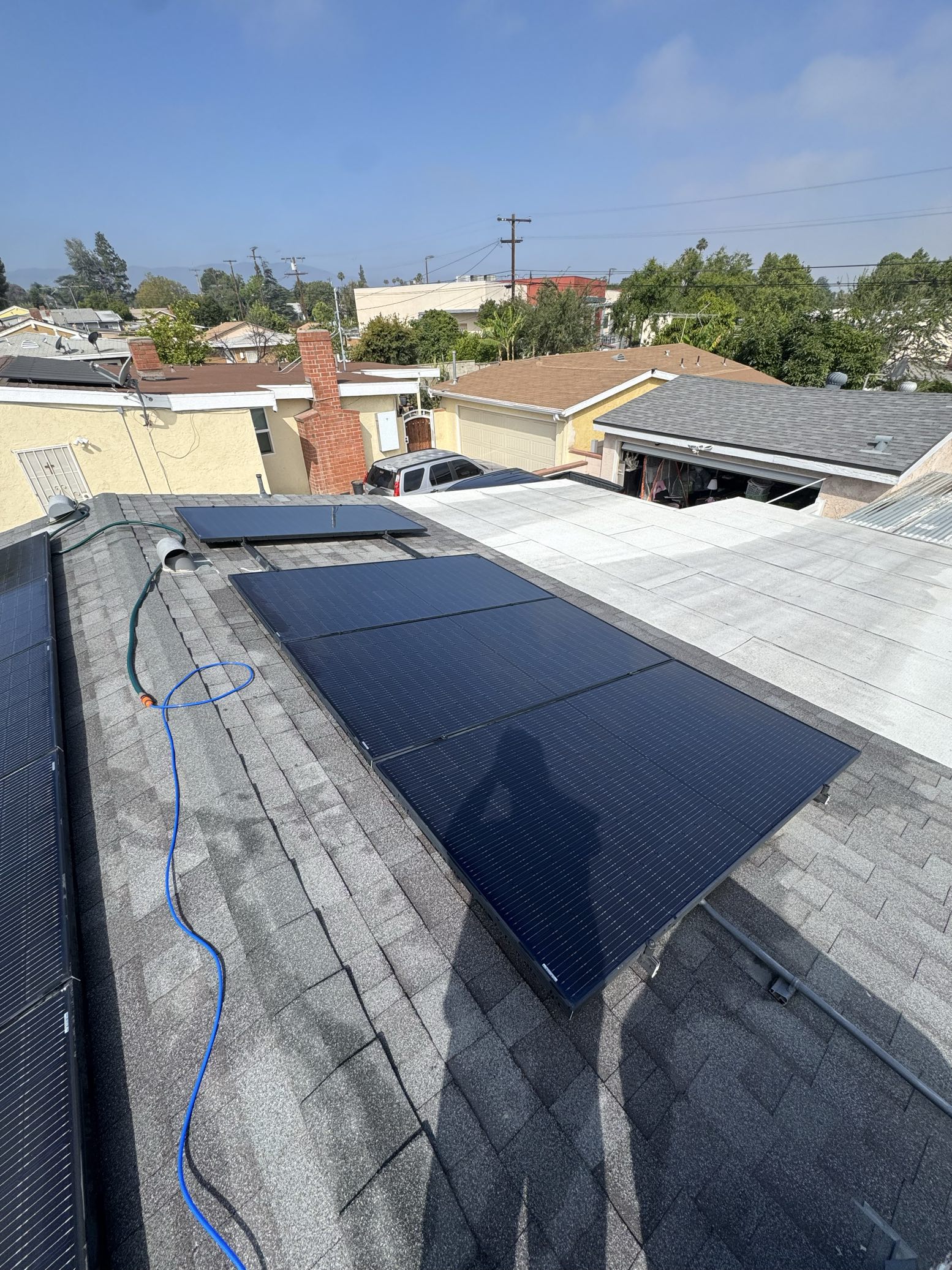 Rooftop solar cleaning with blue hose
