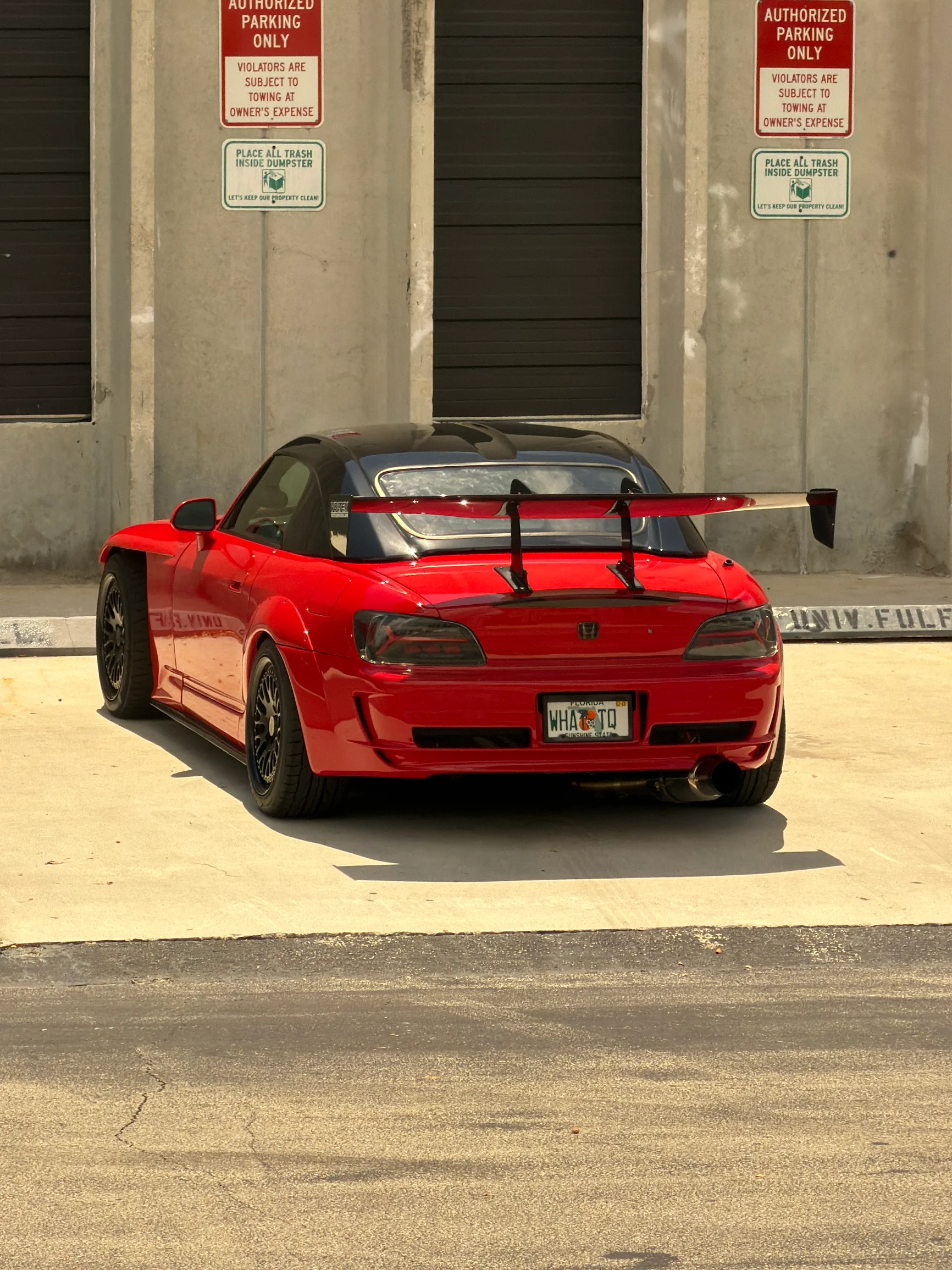 Red Honda S2000 with widebody kit and GT wing after paint and body work at Factory Finish Paint and Body