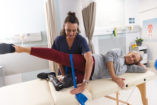 Physiotherapist working with a patient using resistance bands