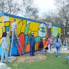 Gesamtansicht der Graffiti-Aktion mit mehreren Malern und Leitern