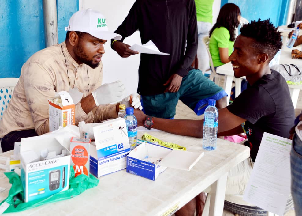 KUTH male volunteer conducting blood test screening