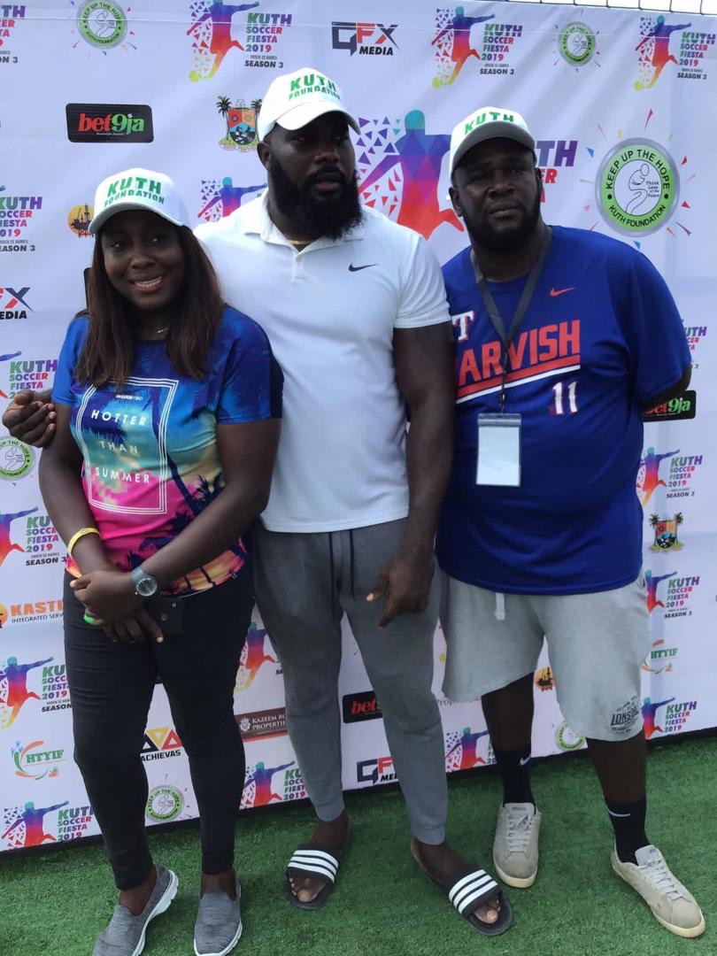 Female volunteer with Founder and official at media wall