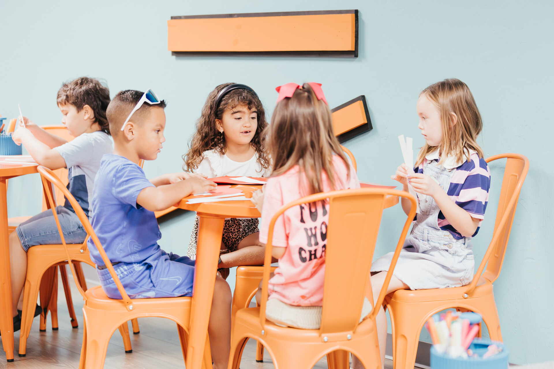 Children doing a craft together at a CG Kids table