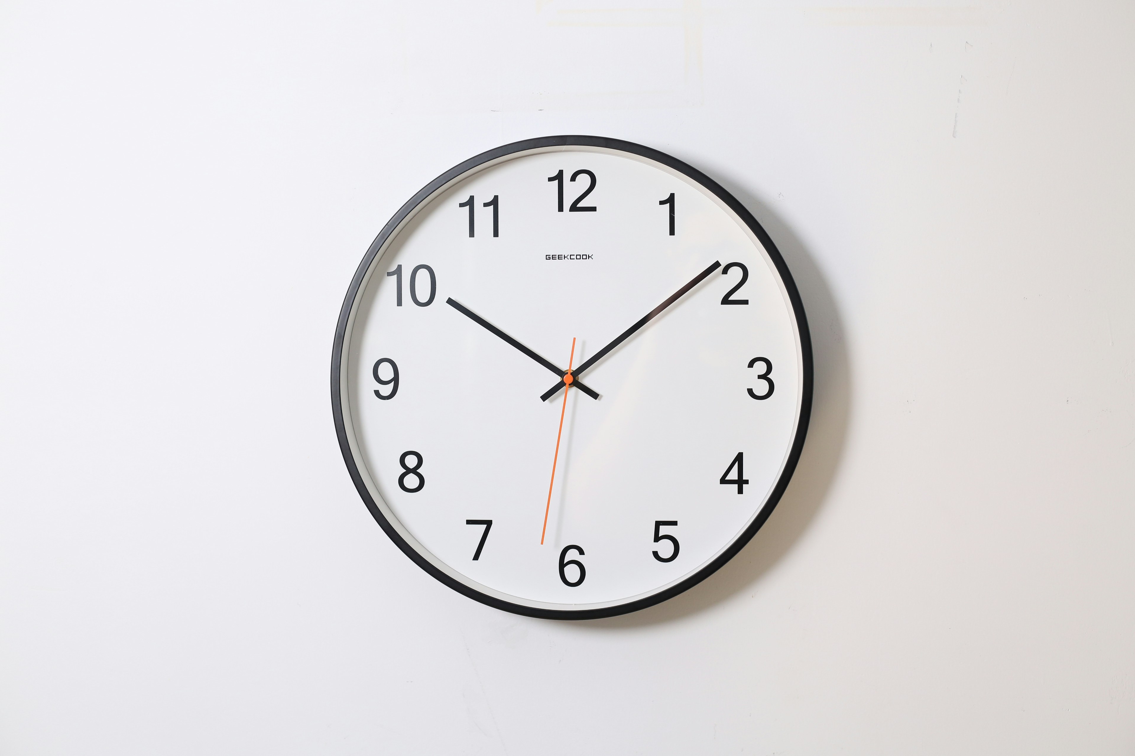 Modern wall clock showing time, representing daily circadian rhythms