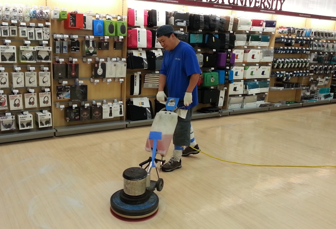 Professional cleaning technician maintaining retail store floor