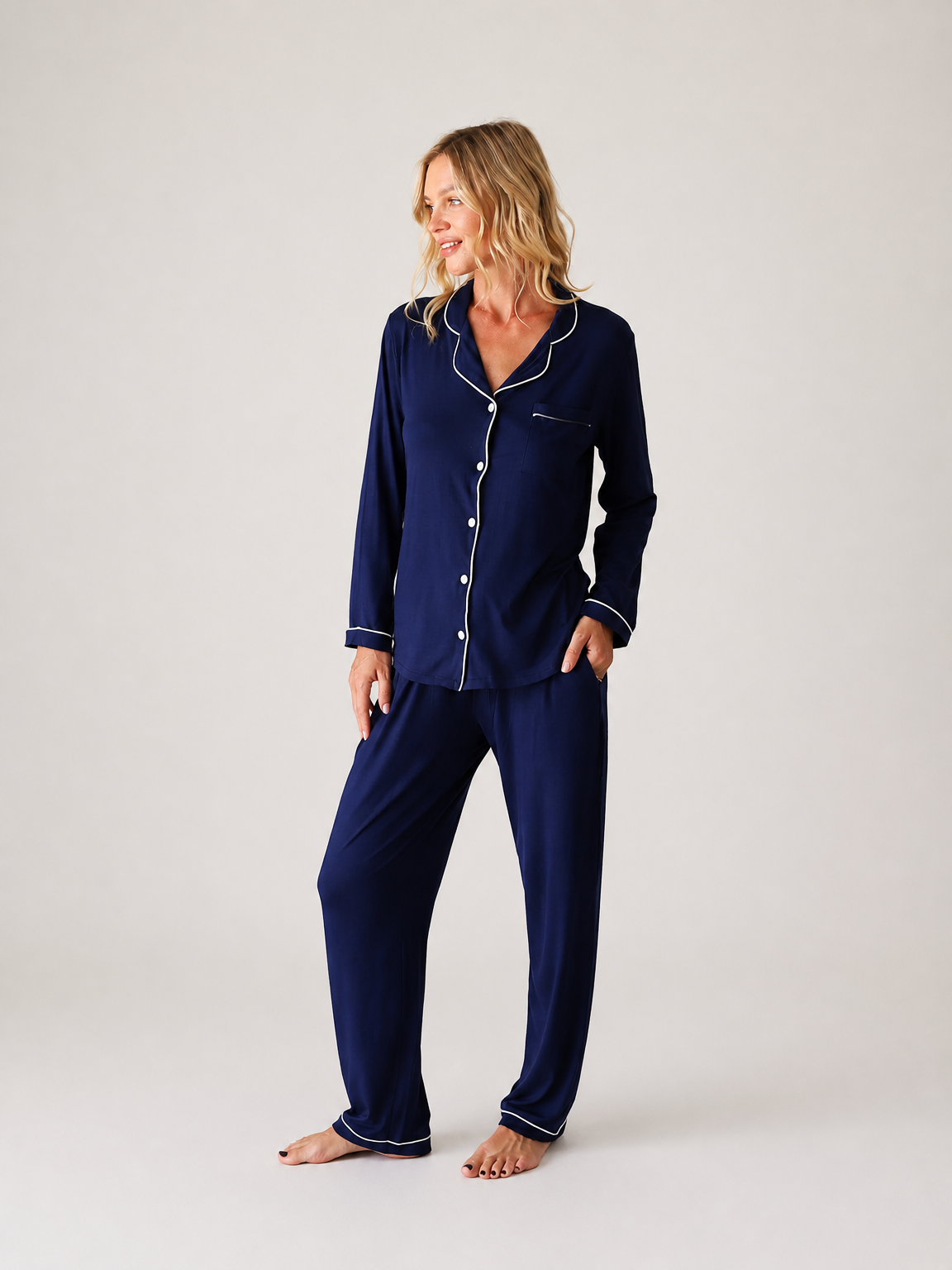 Made from Jersey Modal, this classic navy button-front pajama set pairs a top with matching full-length pants and contrasting white piping.