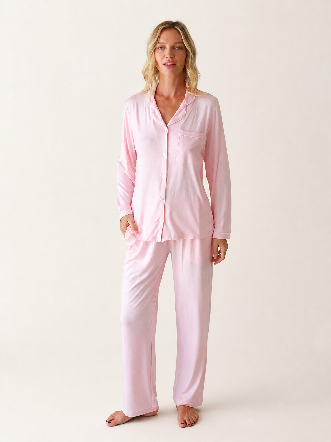 Made from Jersey Modal, this solid soft pink button-front sleep set pairs a shirt with matching full-length pants and subtle piping.