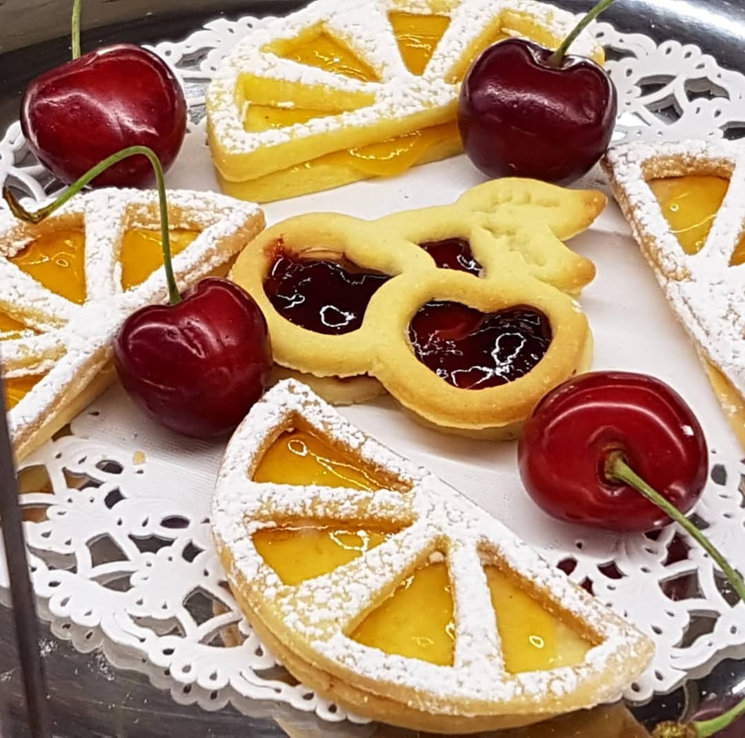 Homemade cookies with jam and fresh cherries
