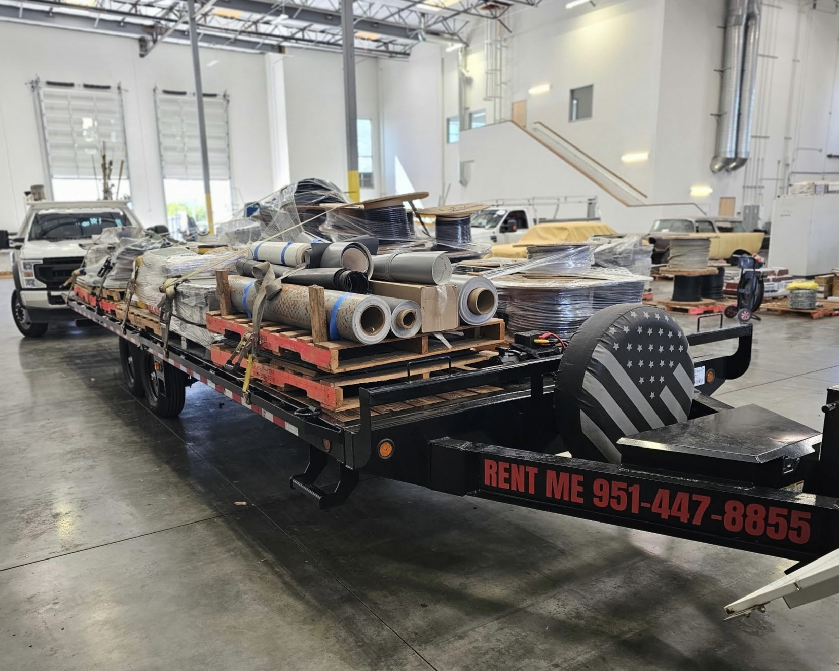 Flatbed trailer loaded with packaged materials inside a commercial facility