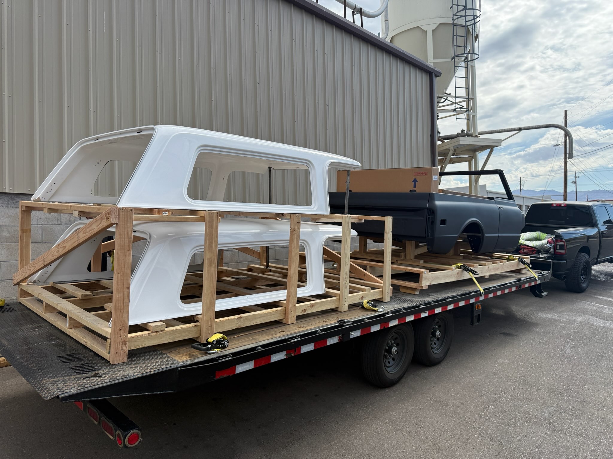 Commercial flatbed trailer carrying a large framed load for a business delivery