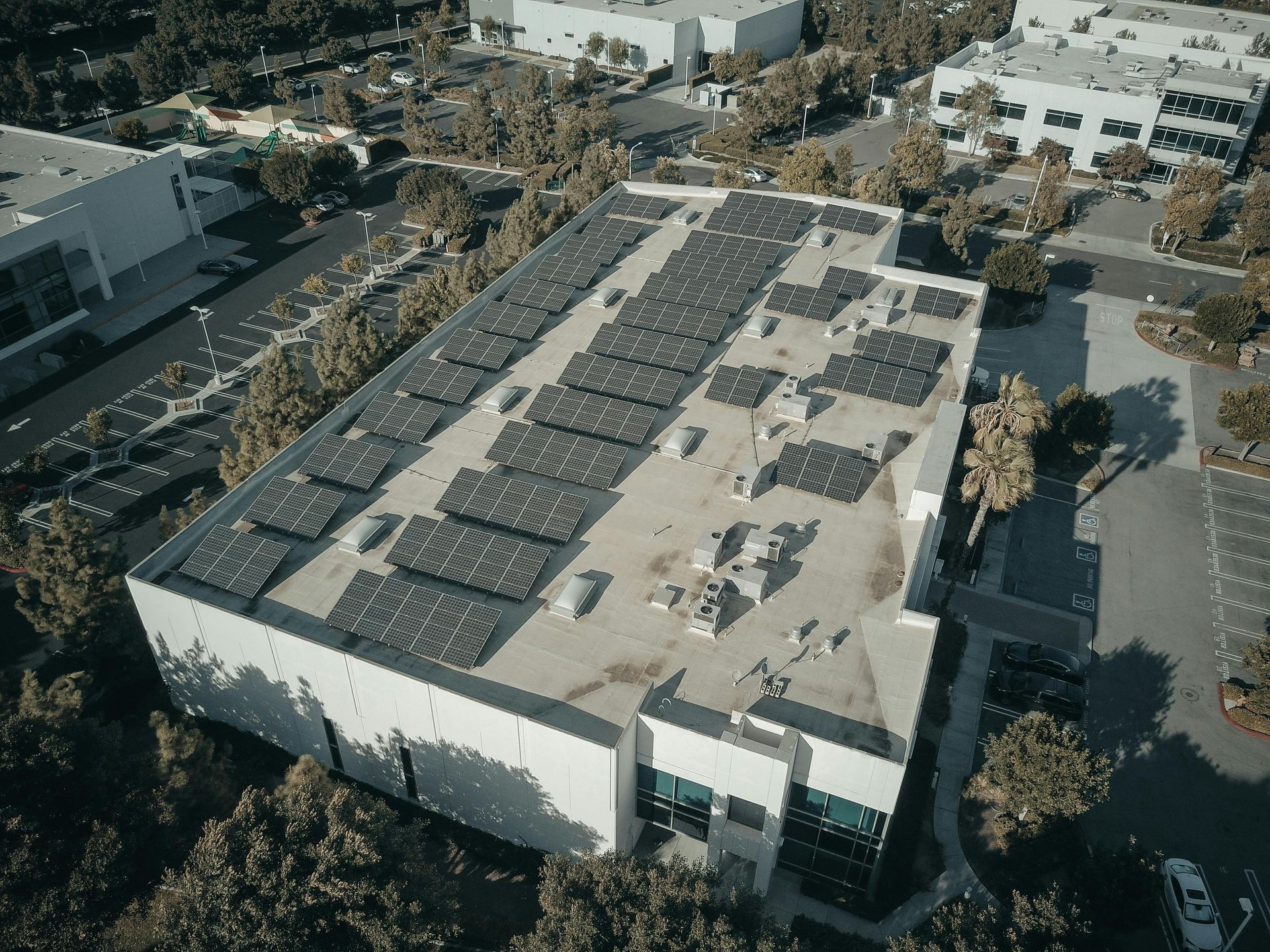 Aerial view of commercial building with rooftop solar array