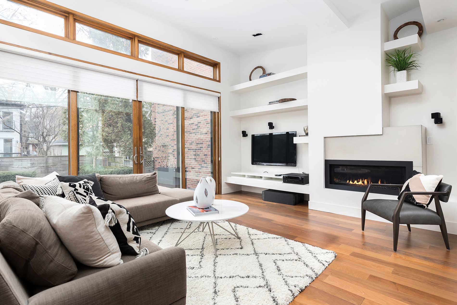 Contemporary living room with linear fireplace and large windows