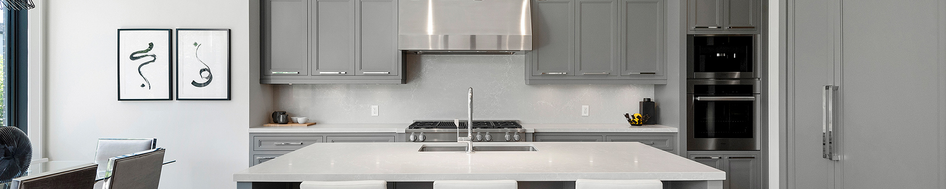Modern kitchen with gray cabinetry and white quartz island