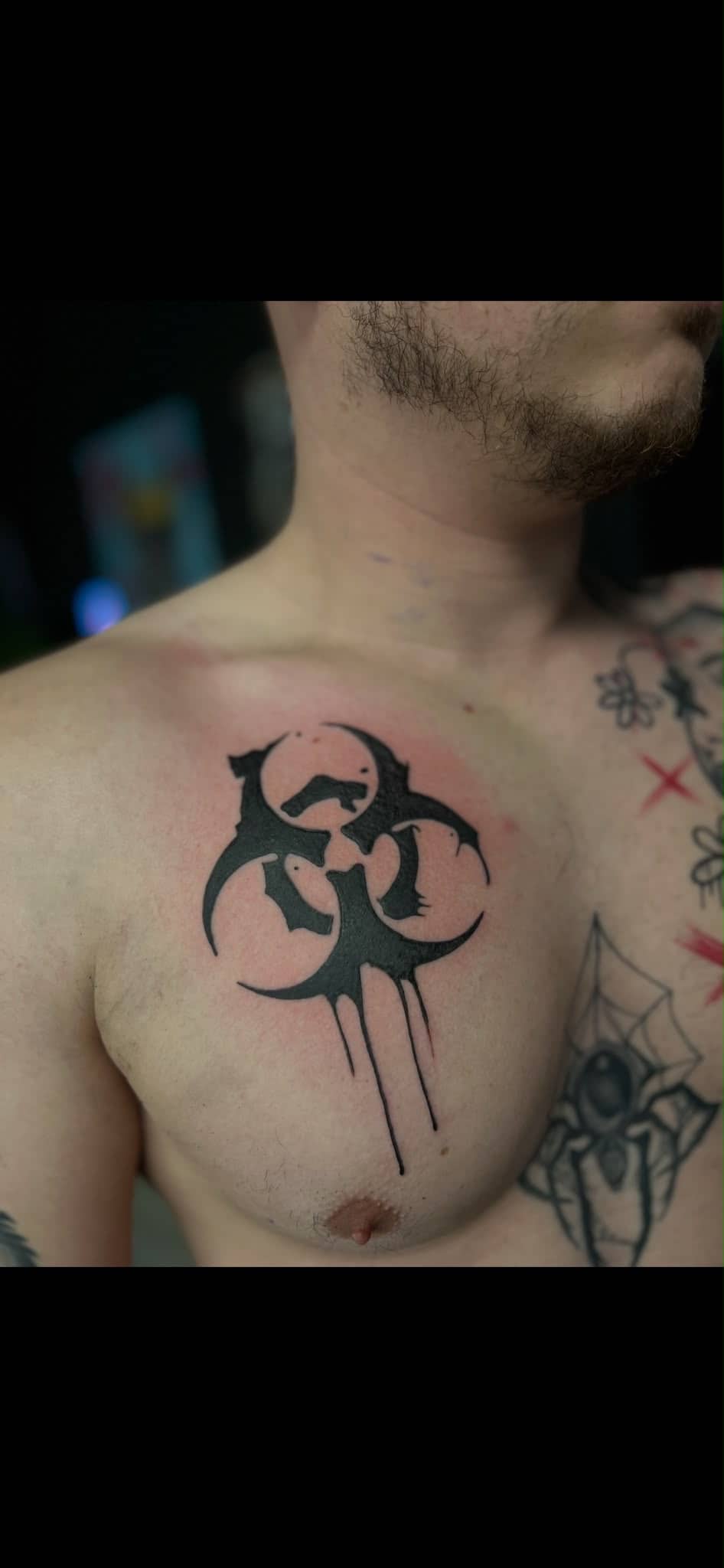 Blackwork Biohazard-Symbol mit Tröpfeln an der Brust