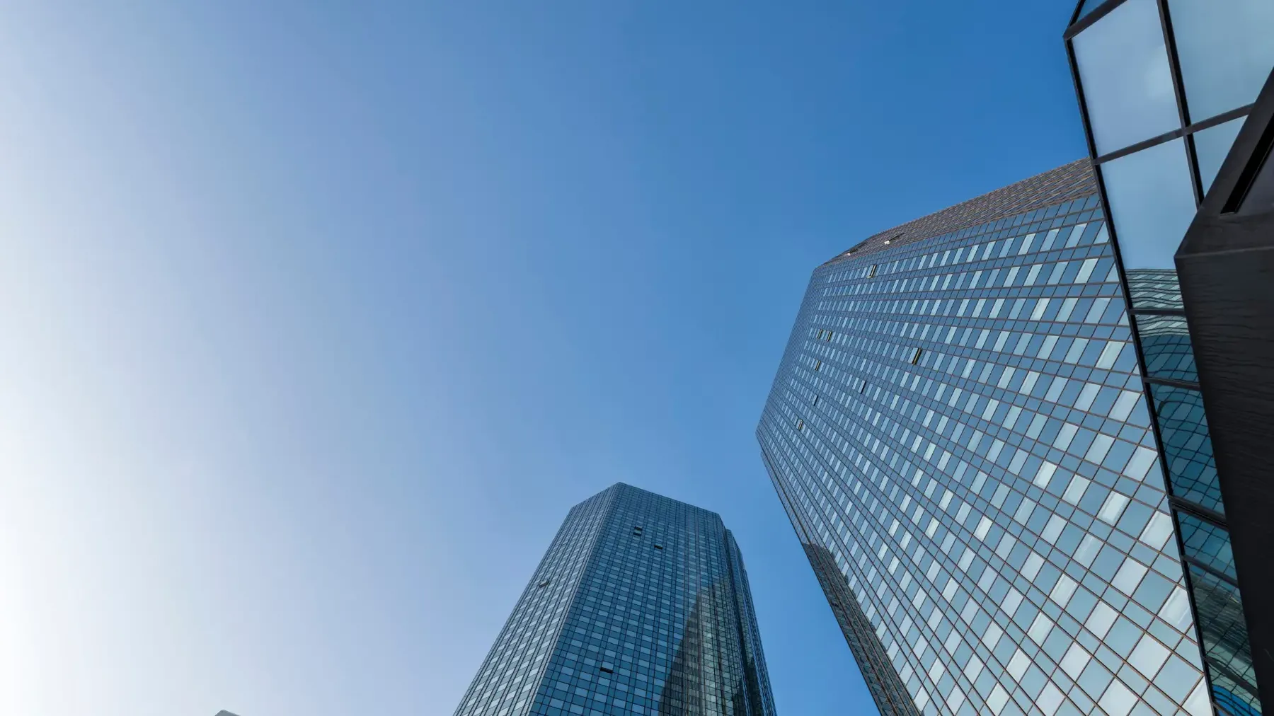 Modern glass skyscrapers against a clear blue sky