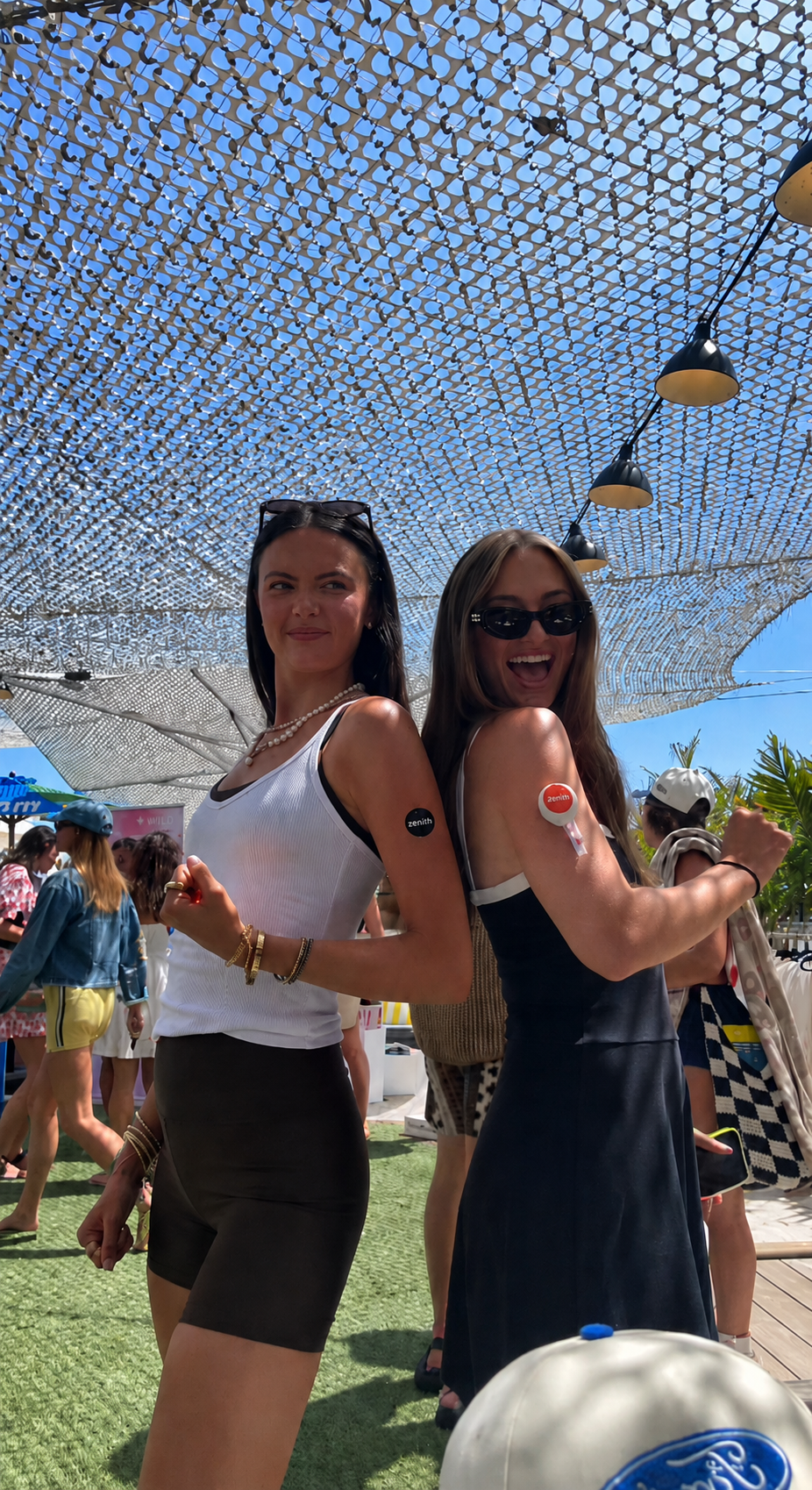 Two friends wearing the Zenith blood collection device outdoors