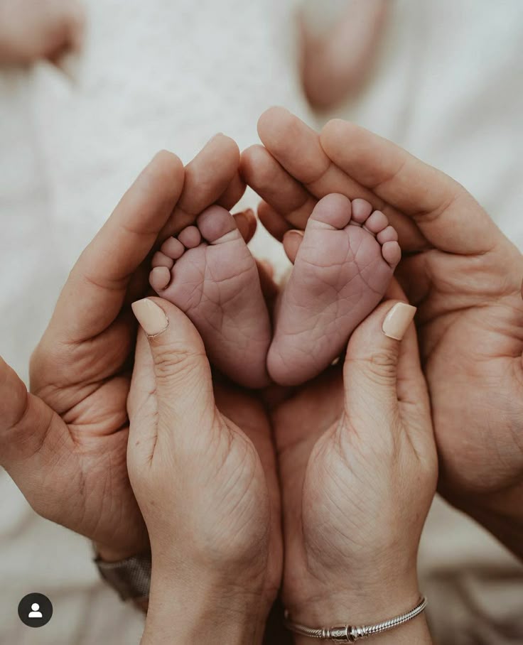 Family care and compassion - Baby held in parents hands
