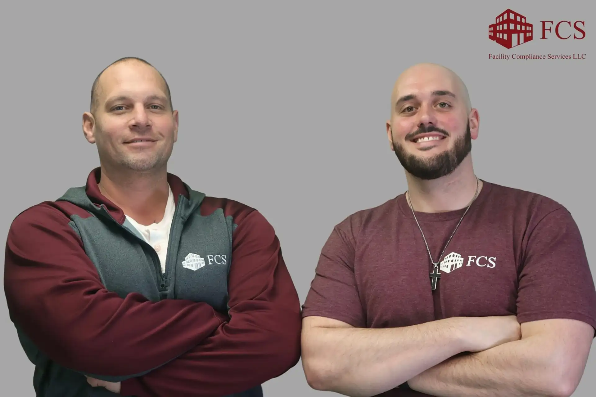Two FCS technicians with crossed arms in branded apparel