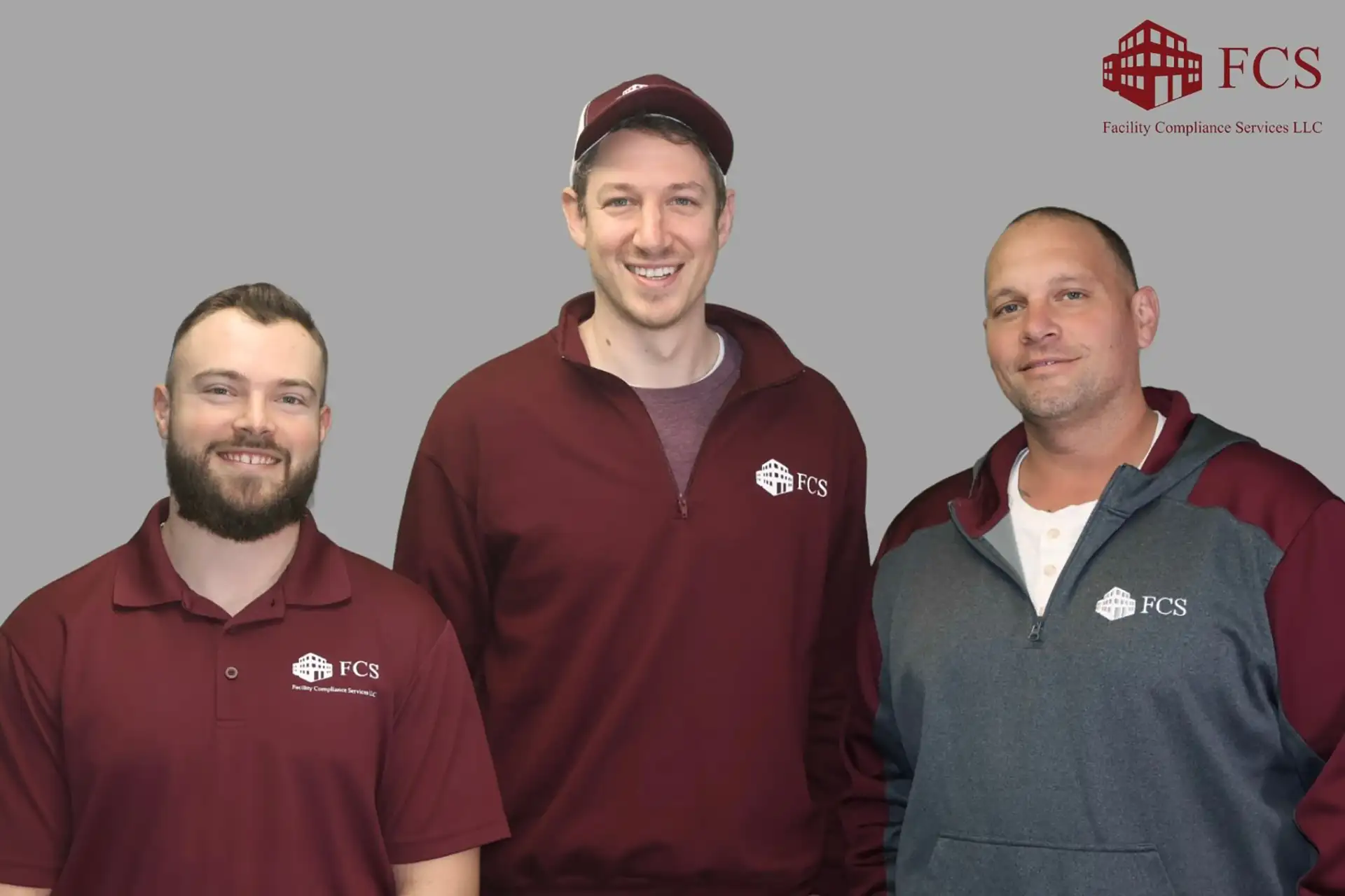 Three FCS field technicians in branded uniforms