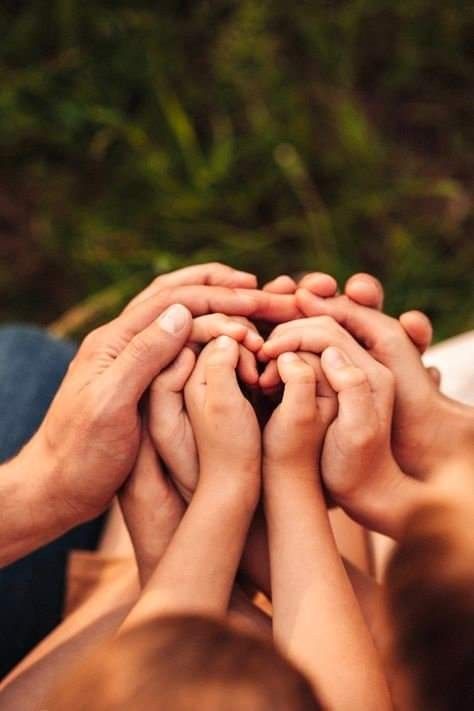Hands stacked together representing unity and community partnership