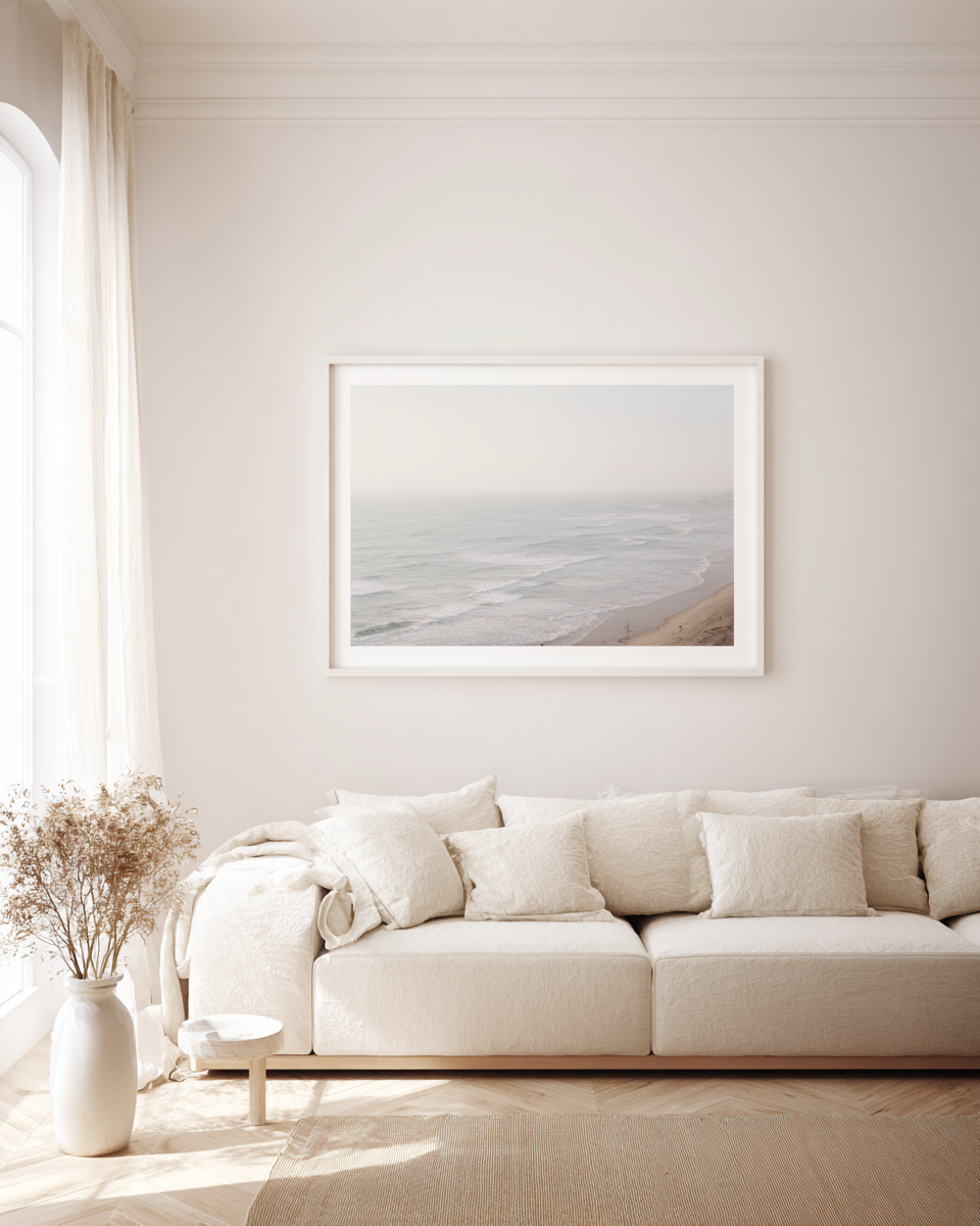 Coastal Silence - Aerial view of misty ocean waves meeting sandy beach in muted tones