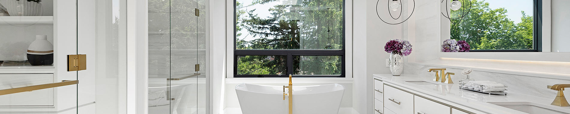 Luxurious white bathroom with freestanding tub and gold fixtures
