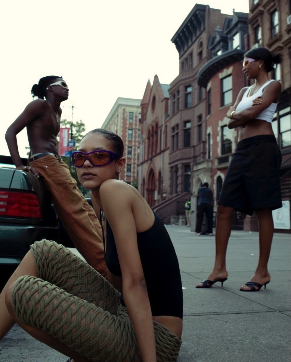 Three women in stylish sunglasses on urban street
