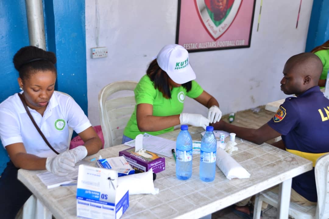 Health workers conducting blood sample collection