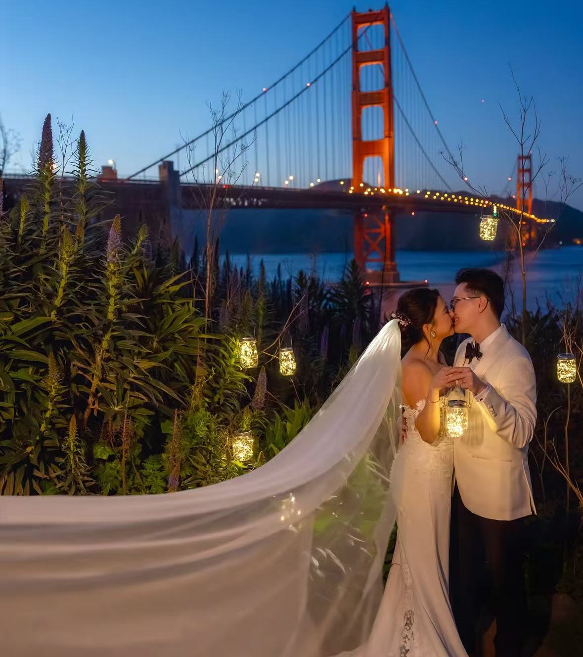 Couple at Golden Gate Bridge at night with fairy lights