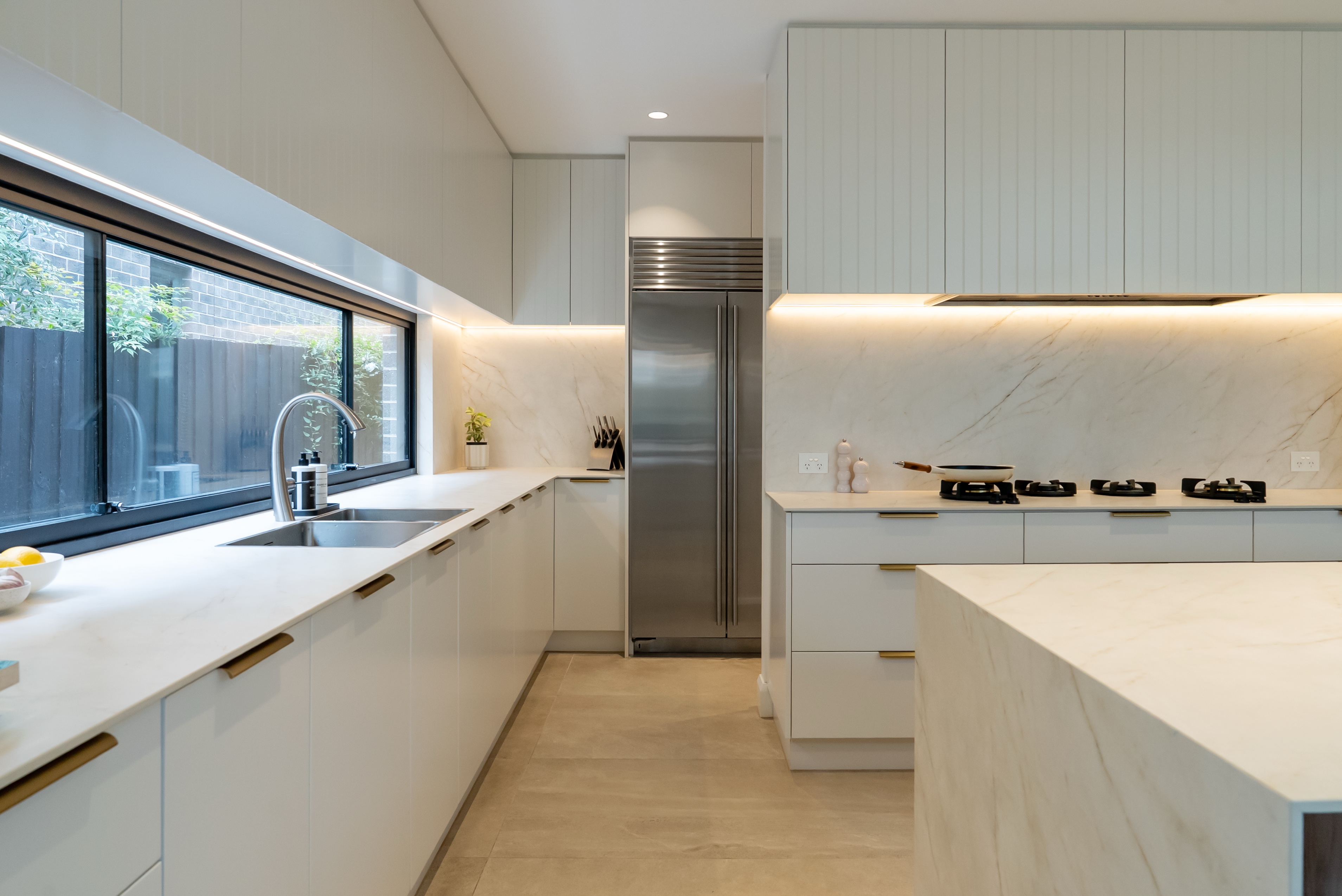 Luxury white kitchen with marble splashback