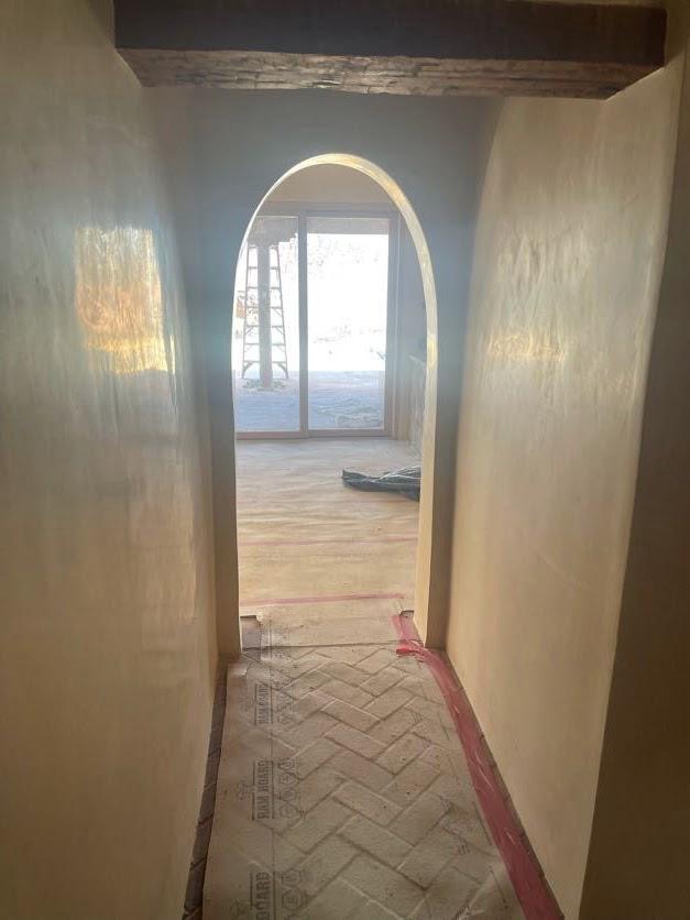 Interior hallway with smooth plaster stucco arched entry