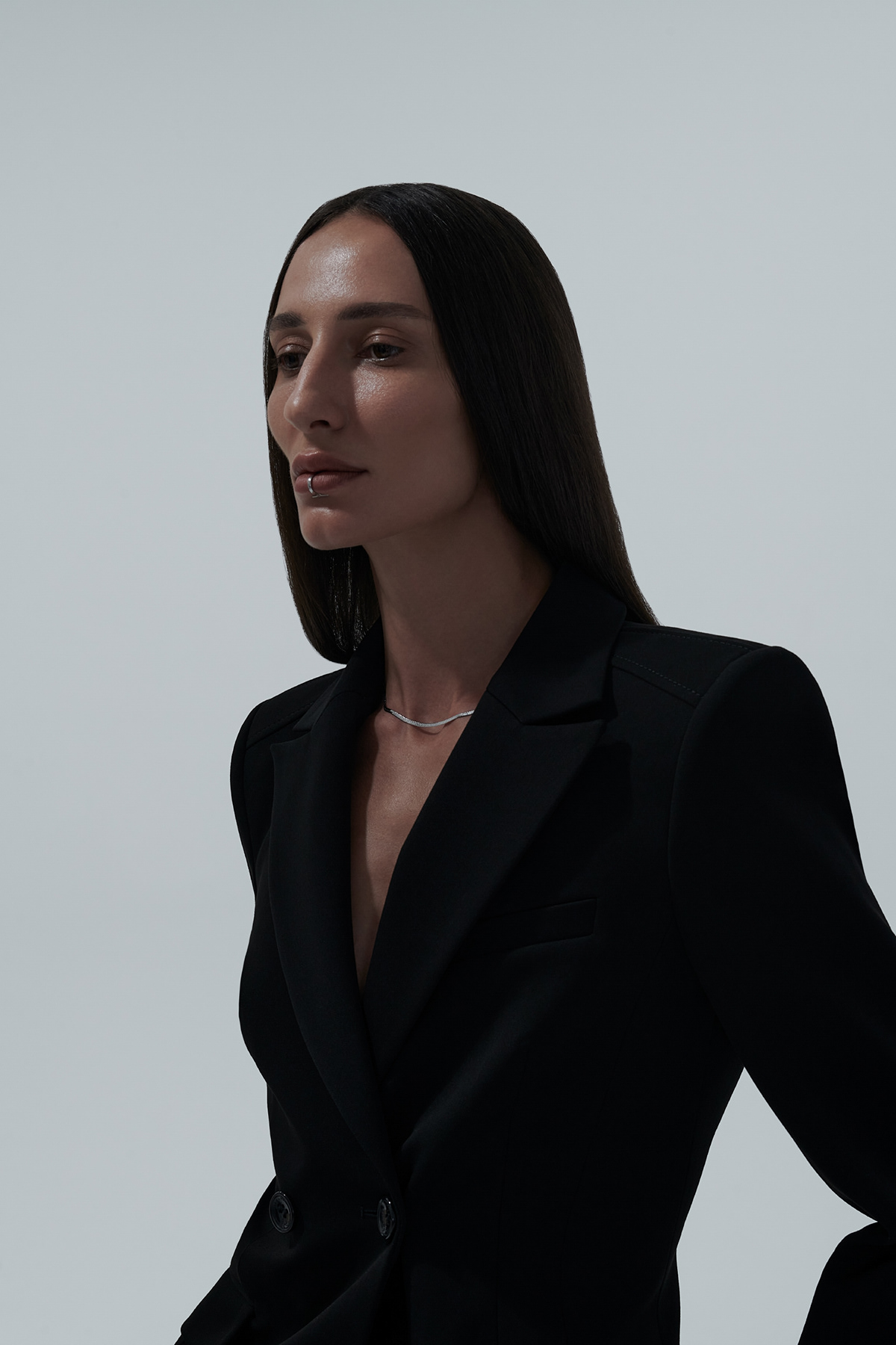 DarkRain — dark blazer, silver tennis necklace, side profile