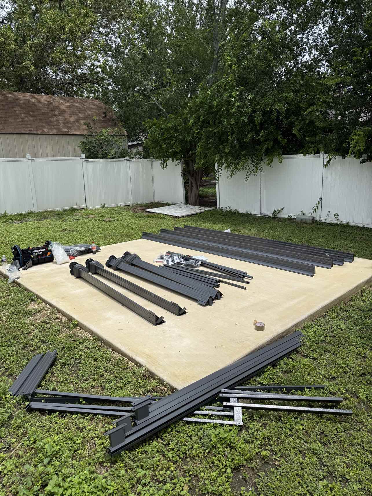 Gazebo parts laid out on concrete slab