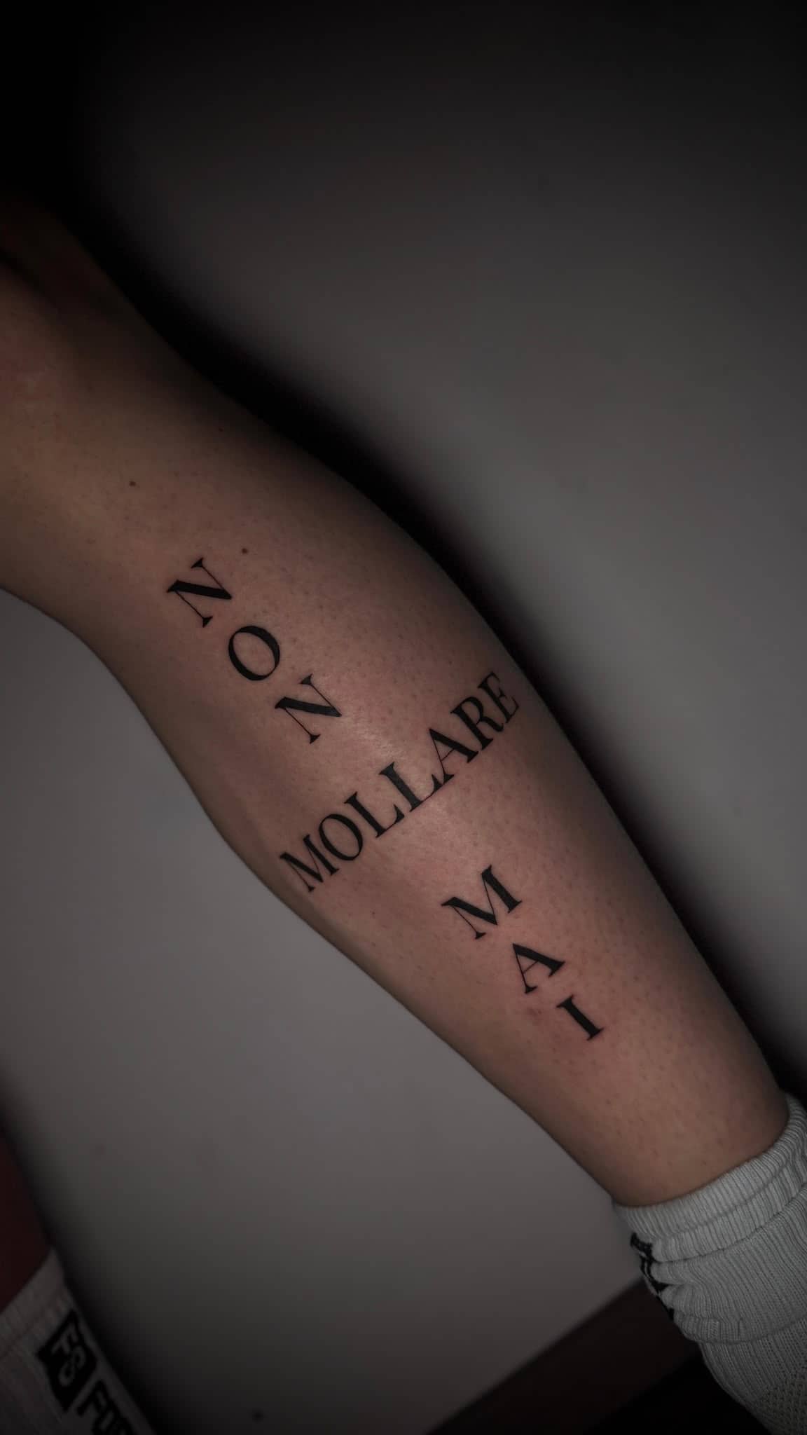 Fineline Non Mollare Mai Schriftzug am Unterarm