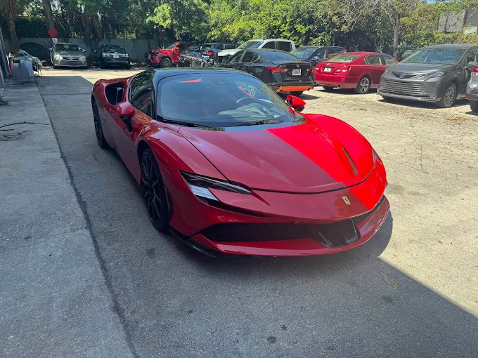 Red Ferrari SF90 front three-quarter view at Factory Finish Paint and Body